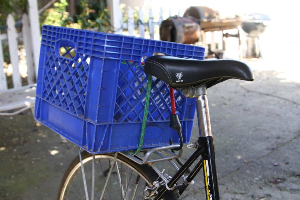 Milk crate attached to the rear of a bike