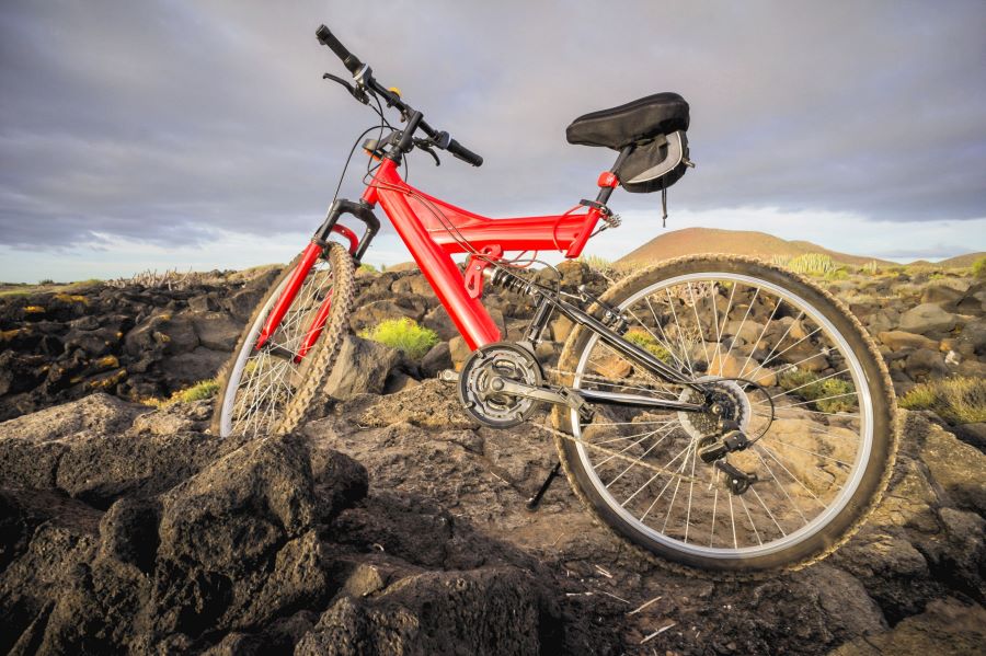 A red mountain bike on a rocky trail