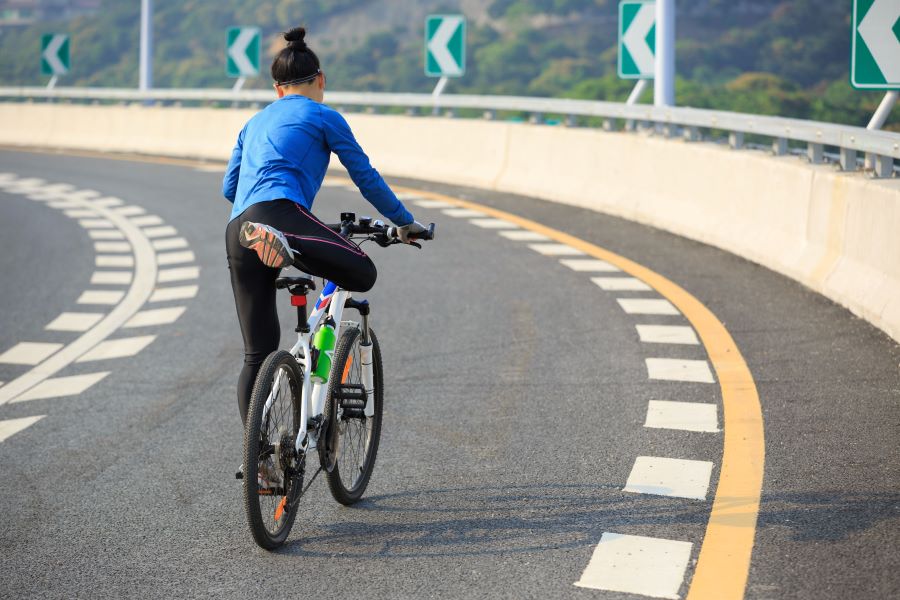 Woman riding a mountain bike on the road