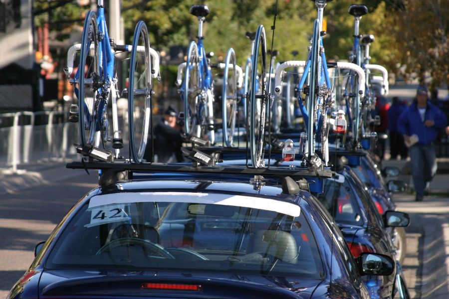 Car with bikes on roof as entourage for professional cyclists