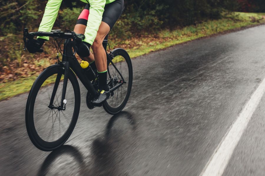 Road cyclist riding on a wet road
