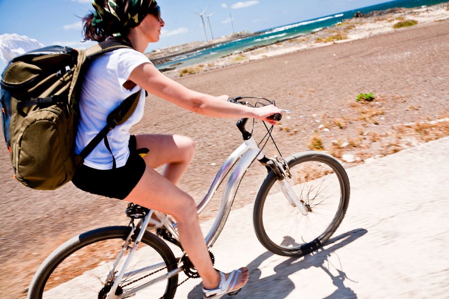 Female cyclist riding near the sea
