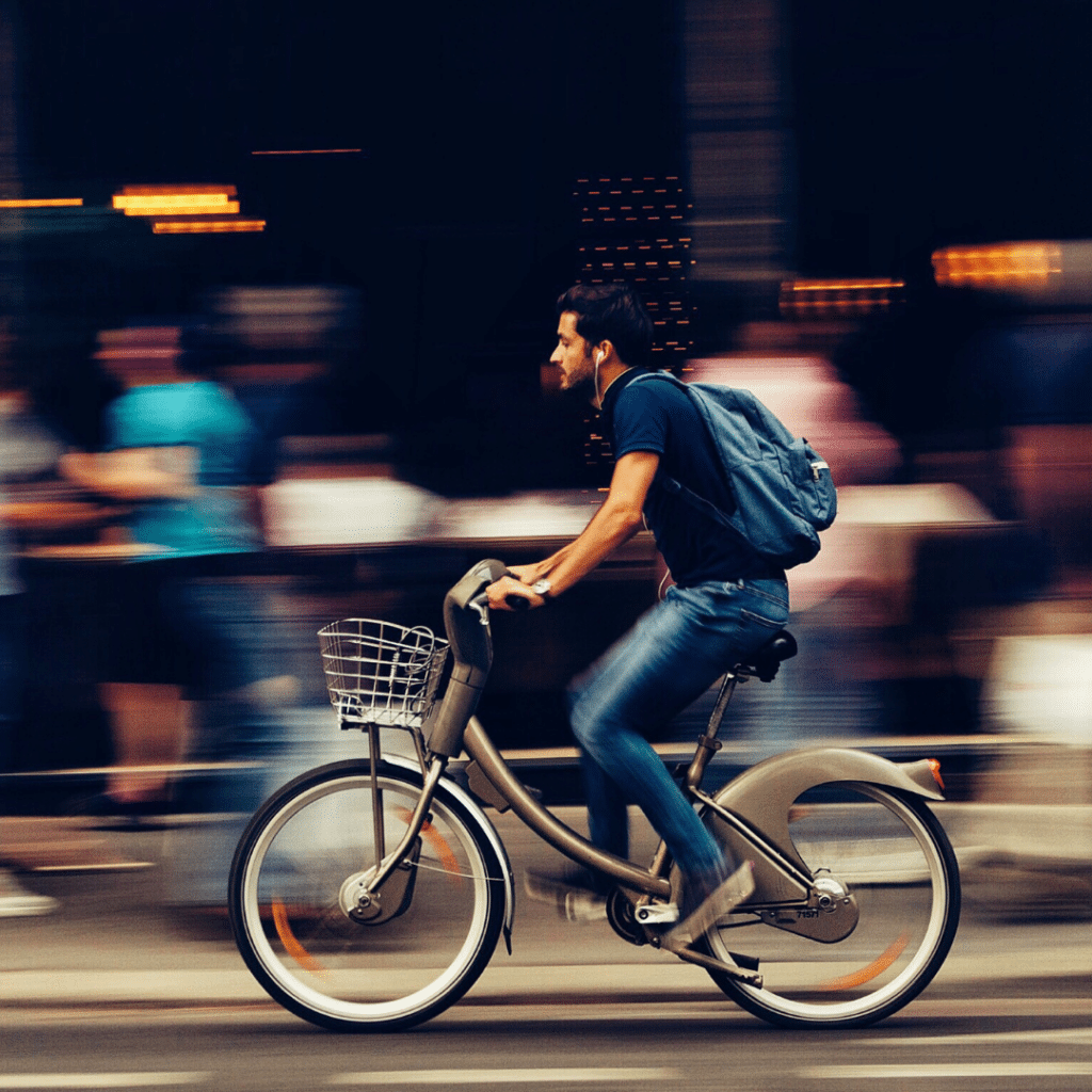 A student riding a city bike to University