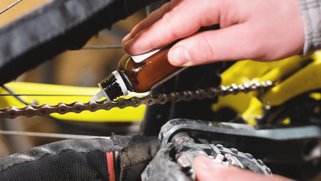 Bike lube being applied to a bike chain