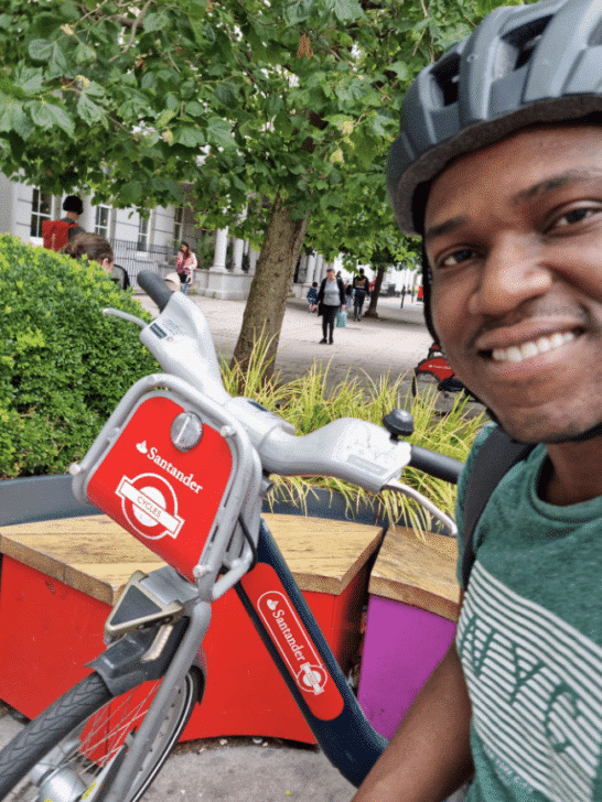 Michael posing next to a bike in London