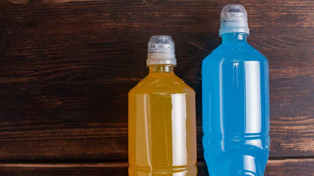 Two sports drinks (one yellow and the other blue)